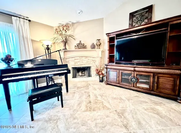 a living room with furniture and a flat screen tv