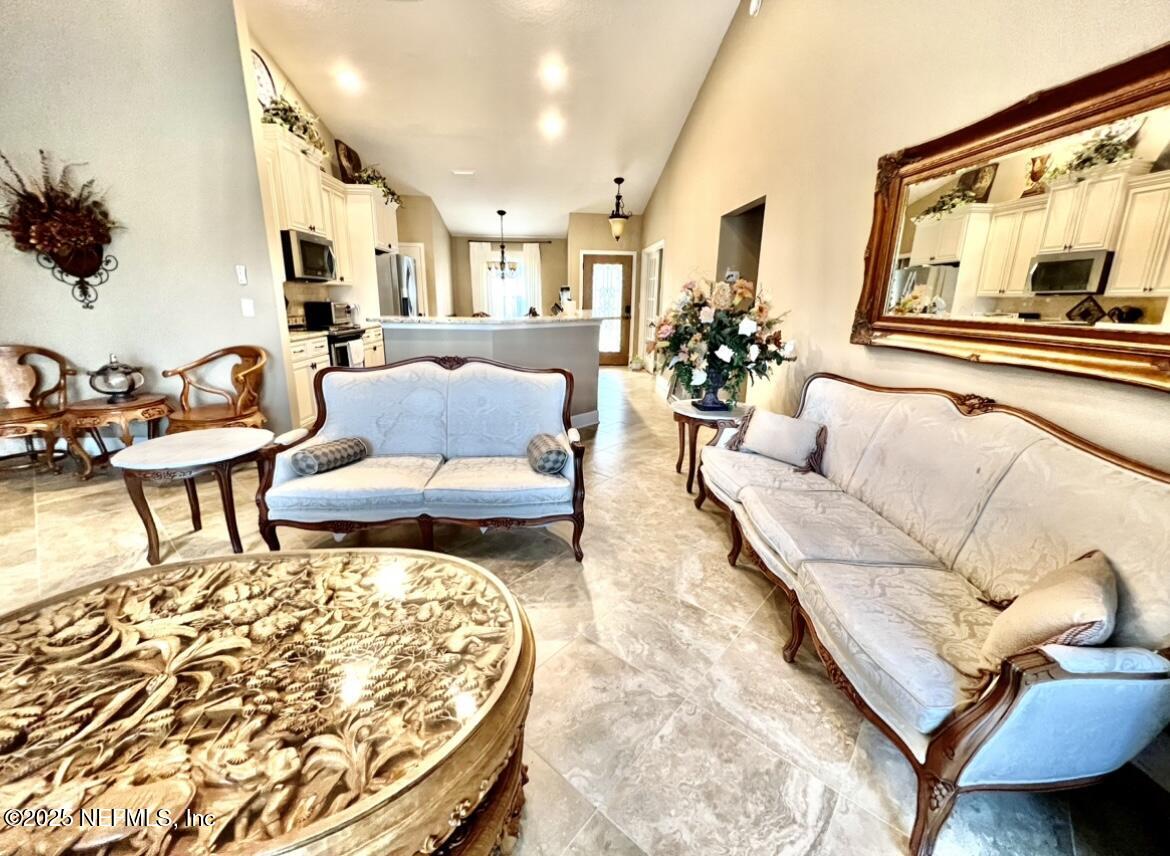 1024 Ardmore Street St. Augustine, FL 32092 - Photo 9 of 25 a living room with furniture and a large mirror next to a window