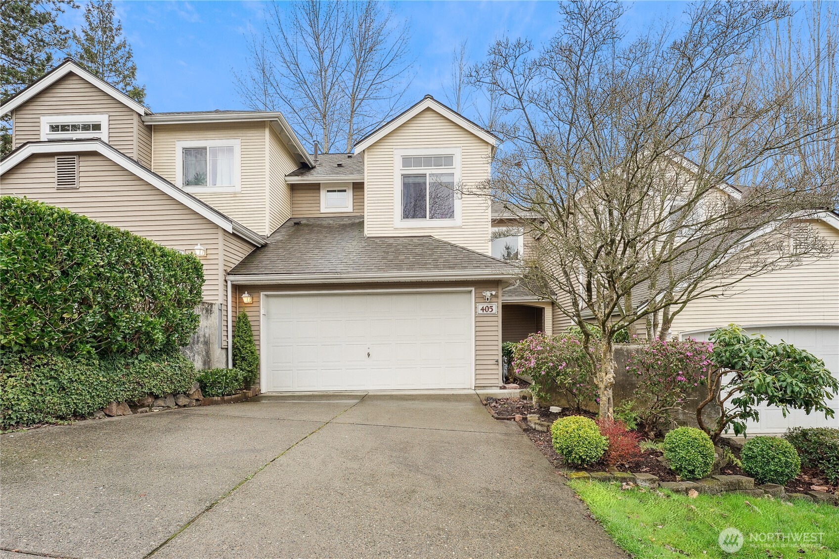 405 South 47th Street, Unit 405 Renton, WA 98055 - Photo 1 of 30 a front view of a house with a yard and garage