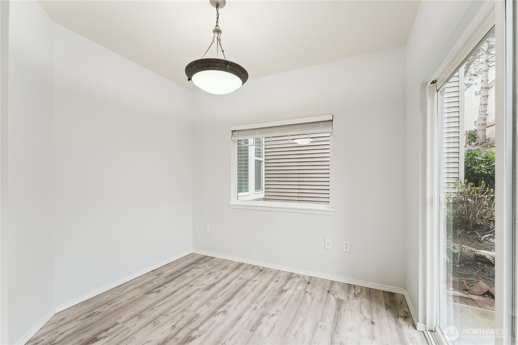 405 South 47th Street, Unit 405 Renton, WA 98055 - Photo 14 of 30 a view of an empty room with a window and wooden floor