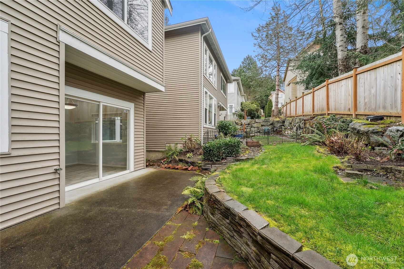 405 South 47th Street, Unit 405 Renton, WA 98055 - Photo 29 of 30 a view of backyard with wooden fence and large trees