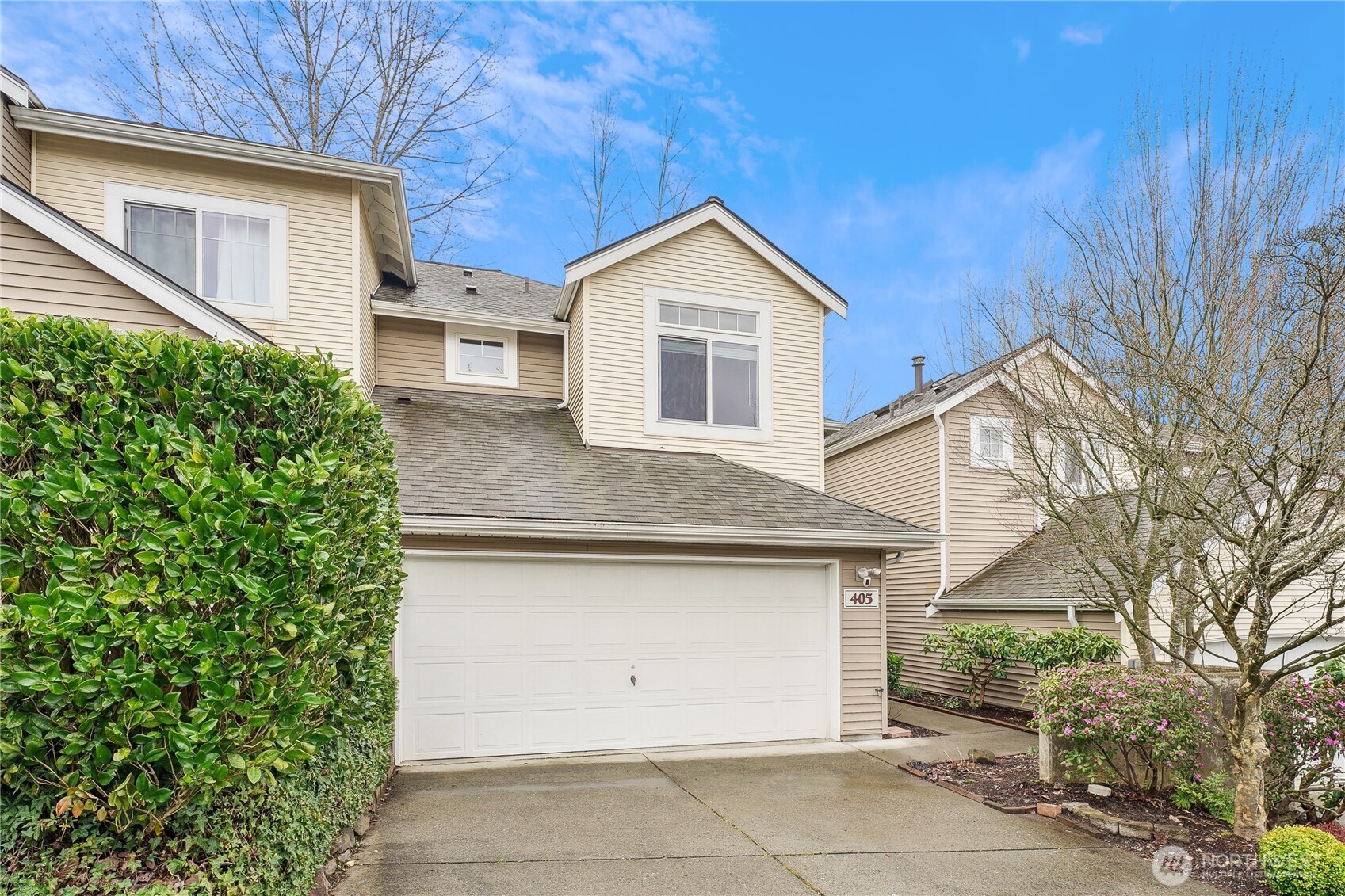405 South 47th Street, Unit 405 Renton, WA 98055 - Photo 30 of 30 a view of a house with a yard and garage