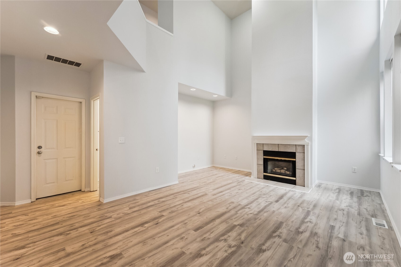 405 South 47th Street, Unit 405 Renton, WA 98055 - Photo 4 of 30 a view of empty room with wooden floor and fireplace