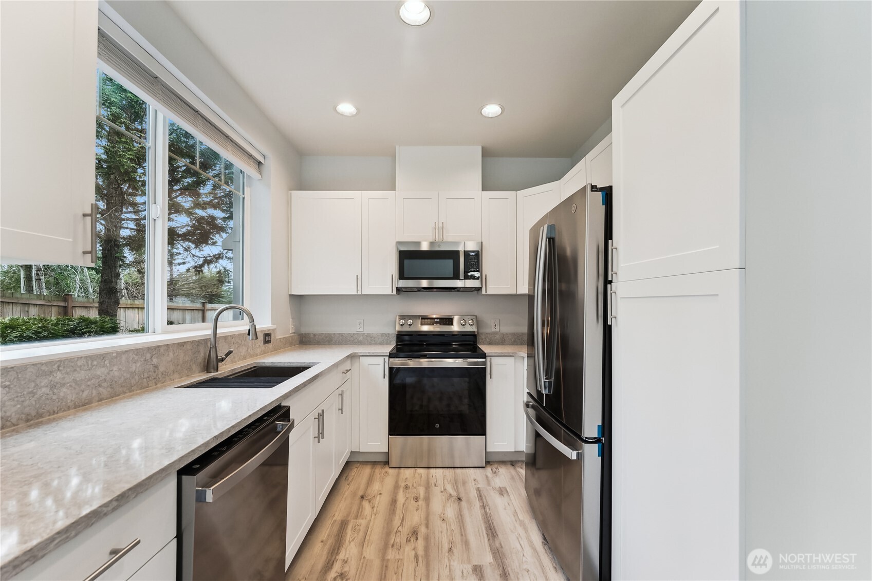 405 South 47th Street, Unit 405 Renton, WA 98055 - Photo 10 of 30 a kitchen with a sink stove and refrigerator