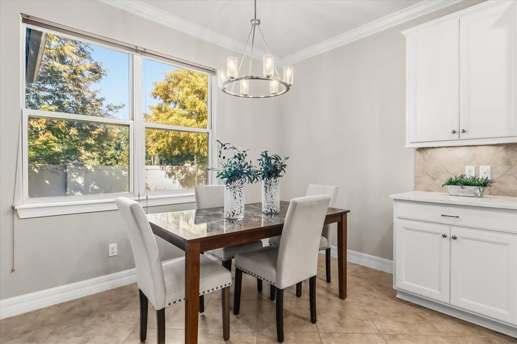 10713 BERRY CREEK Road Orlando, FL 32836 - Photo 11 of 60 a dining room with furniture a rug and a chandelier