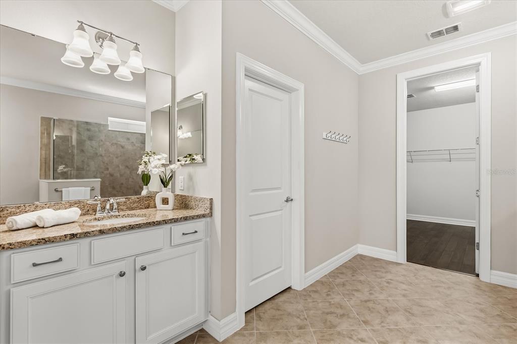 10713 BERRY CREEK Road Orlando, FL 32836 - Photo 14 of 59 a bathroom with a granite countertop sink and a mirror