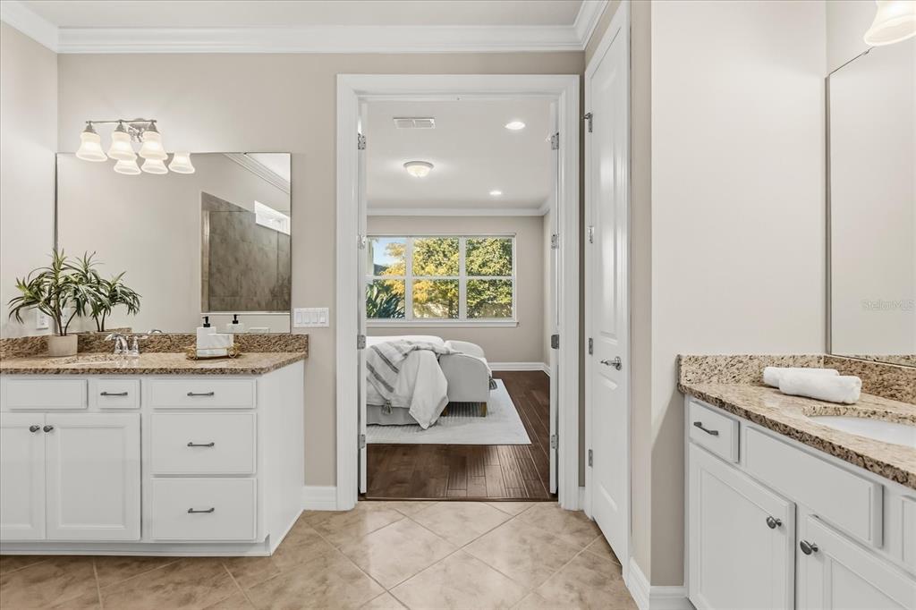 10713 BERRY CREEK Road Orlando, FL 32836 - Photo 15 of 60 a en suite bathroom with a granite countertop sink and a mirror