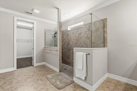 a bathroom with a granite countertop sink a toilet a mirror a bathtub and shower