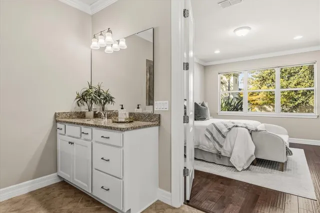 a dining room with furniture and a potted plant