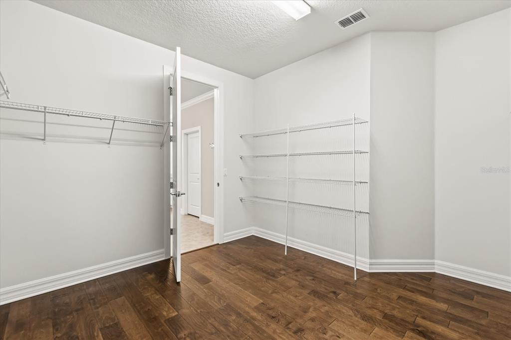 10713 BERRY CREEK Road Orlando, FL 32836 - Photo 18 of 59 an empty walk in closet with wooden floor