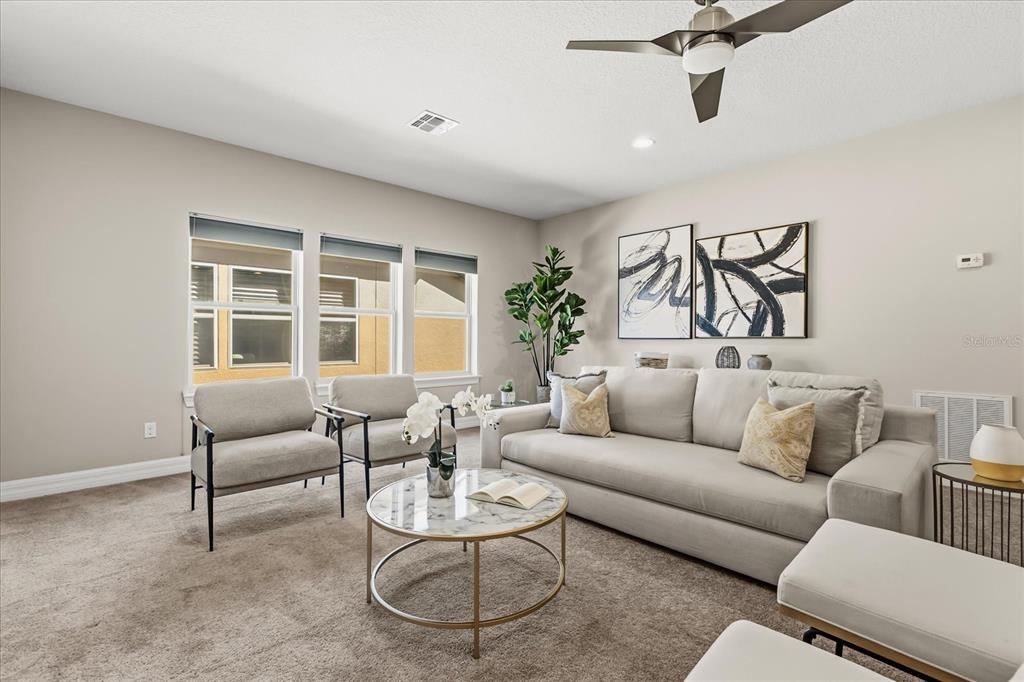 10713 BERRY CREEK Road Orlando, FL 32836 - Photo 23 of 60 a living room with furniture and a large window