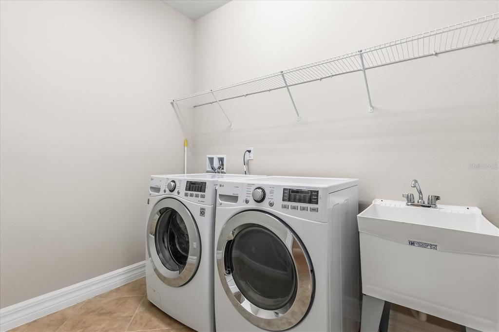 10713 BERRY CREEK Road Orlando, FL 32836 - Photo 31 of 59 a utility room with dryer and washer