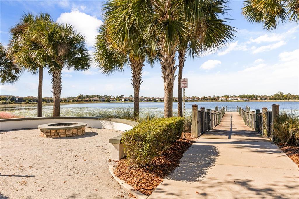 10713 BERRY CREEK Road Orlando, FL 32836 - Photo 39 of 60 a view of a lake with palm trees next to a yard