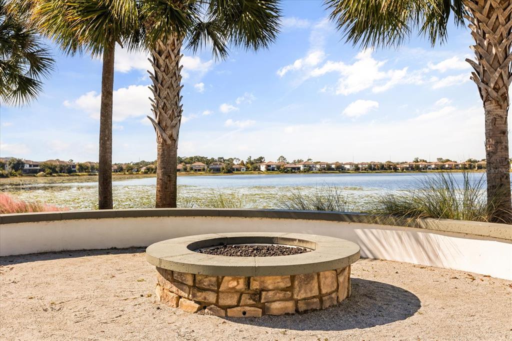 10713 BERRY CREEK Road Orlando, FL 32836 - Photo 40 of 60 a view of a lake with a table and chairs