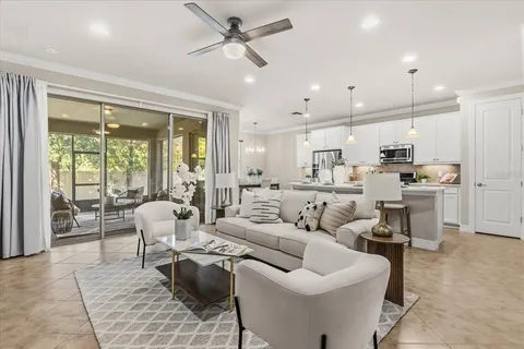 a living room with furniture kitchen view and a refrigerator
