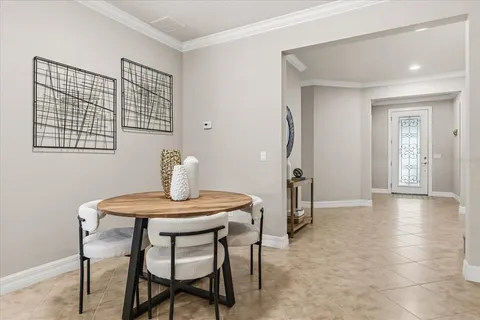 a living room with furniture kitchen view and a refrigerator