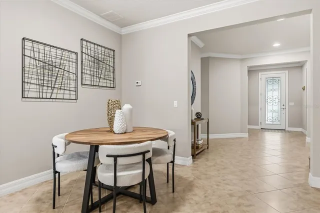 a living room with furniture kitchen view and a refrigerator