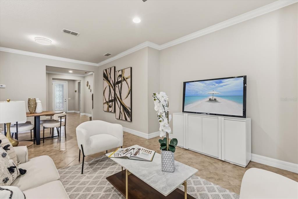 10713 BERRY CREEK Road Orlando, FL 32836 - Photo 6 of 59 a living room with furniture a rug and a table