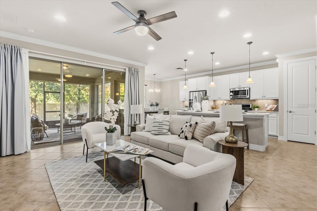 10713 BERRY CREEK Road Orlando, FL 32836 - Photo 6 of 60 a living room with furniture and a large window with kitchen view
