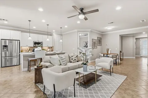 a kitchen with stainless steel appliances kitchen island granite countertop a sink a stove a refrigerator and island with wooden floor