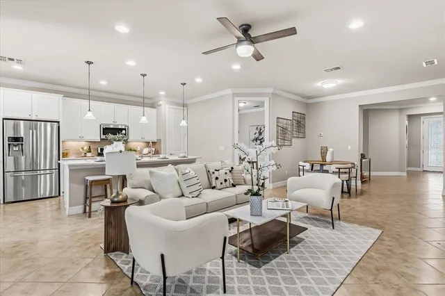 a kitchen with stainless steel appliances kitchen island granite countertop a sink a stove a refrigerator and island with wooden floor