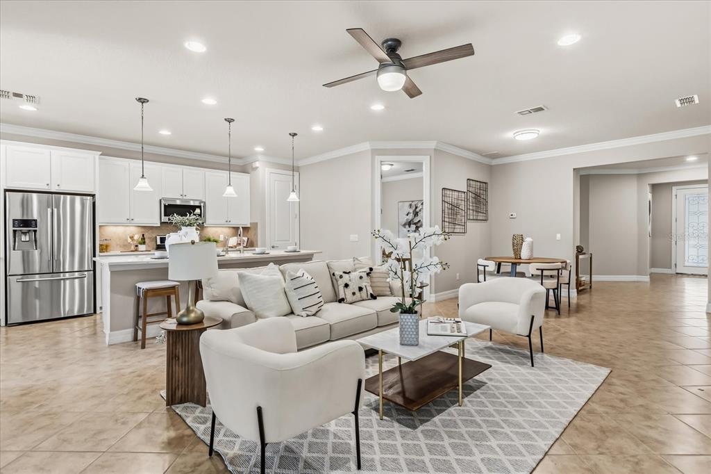 10713 BERRY CREEK Road Orlando, FL 32836 - Photo 7 of 60 a living room with furniture kitchen view and a refrigerator