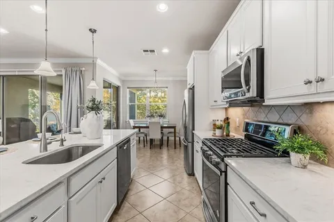 a en suite bathroom with a granite countertop sink and a mirror