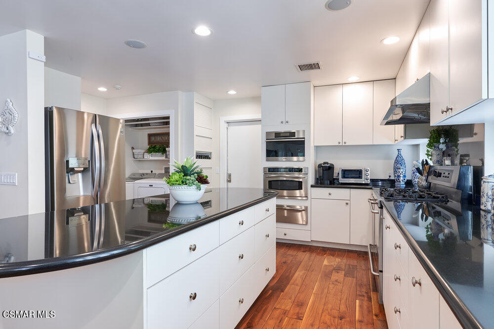 1999 Erbes Road Thousand Oaks, CA 91362 - Photo 20 of 55 a kitchen with white cabinets and stainless steel appliances