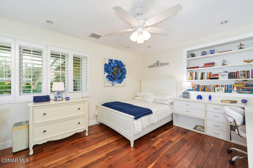 1999 Erbes Road Thousand Oaks, CA 91362 - Photo 23 of 55 a bedroom with a bed and a bookshelf
