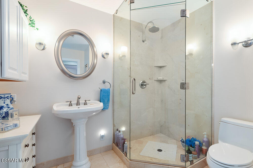 1999 Erbes Road Thousand Oaks, CA 91362 - Photo 32 of 55 a bathroom with a sink mirror toilet and shower
