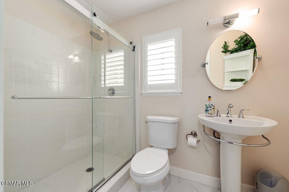 1999 Erbes Road Thousand Oaks, CA 91362 - Photo 35 of 55 a bathroom with a toilet a sink and a mirror