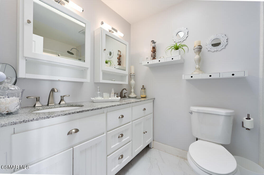 1999 Erbes Road Thousand Oaks, CA 91362 - Photo 36 of 55 a bathroom with a granite countertop toilet sink and mirror