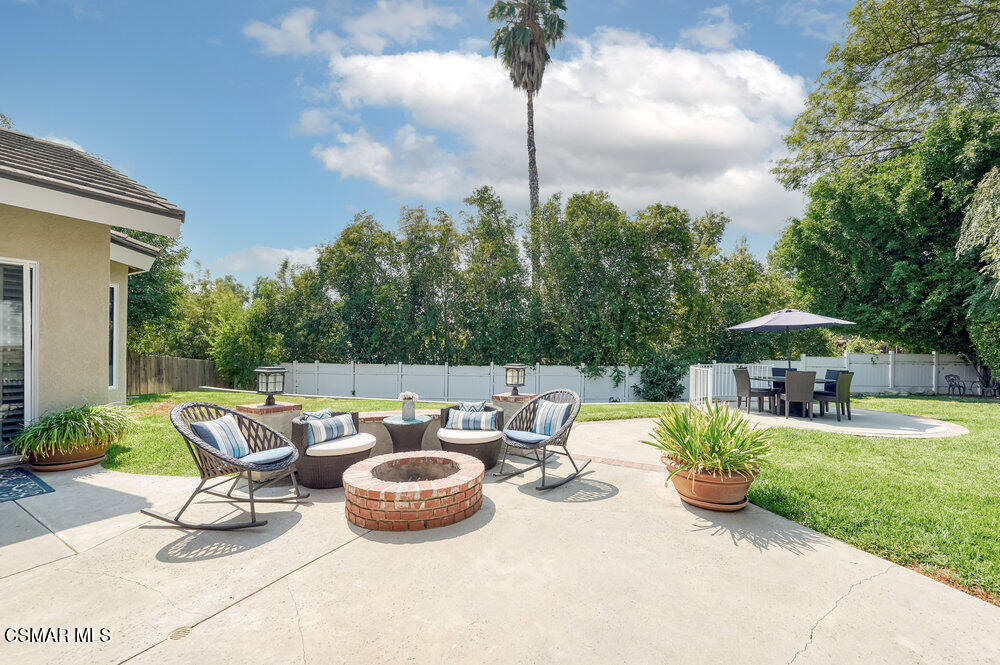1999 Erbes Road Thousand Oaks, CA 91362 - Photo 55 of 55 a view of a patio with furniture and a table and chairs under an umbrella