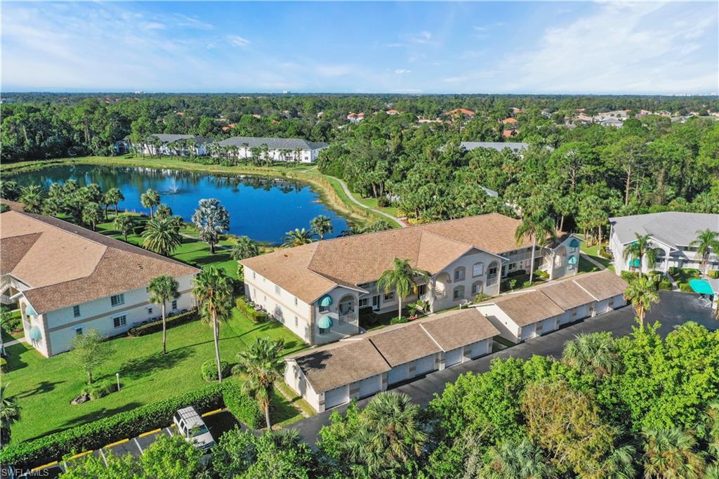 249 Gabriel Circle, Unit 12 Naples, FL 34104 - Photo 1 of 40 an aerial view of house with yard swimming pool and outdoor seating
