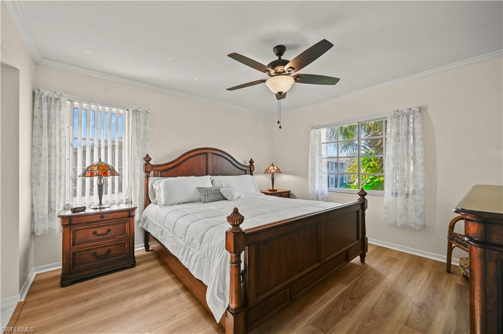 249 Gabriel Circle, Unit 12 Naples, FL 34104 - Photo 14 of 40 a bedroom with a bed and a window