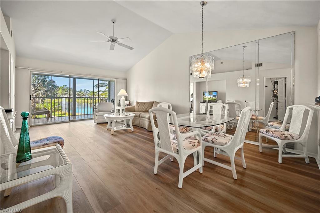 249 Gabriel Circle, Unit 12 Naples, FL 34104 - Photo 2 of 40 a view of a dining room with furniture wooden floor and a chandelier