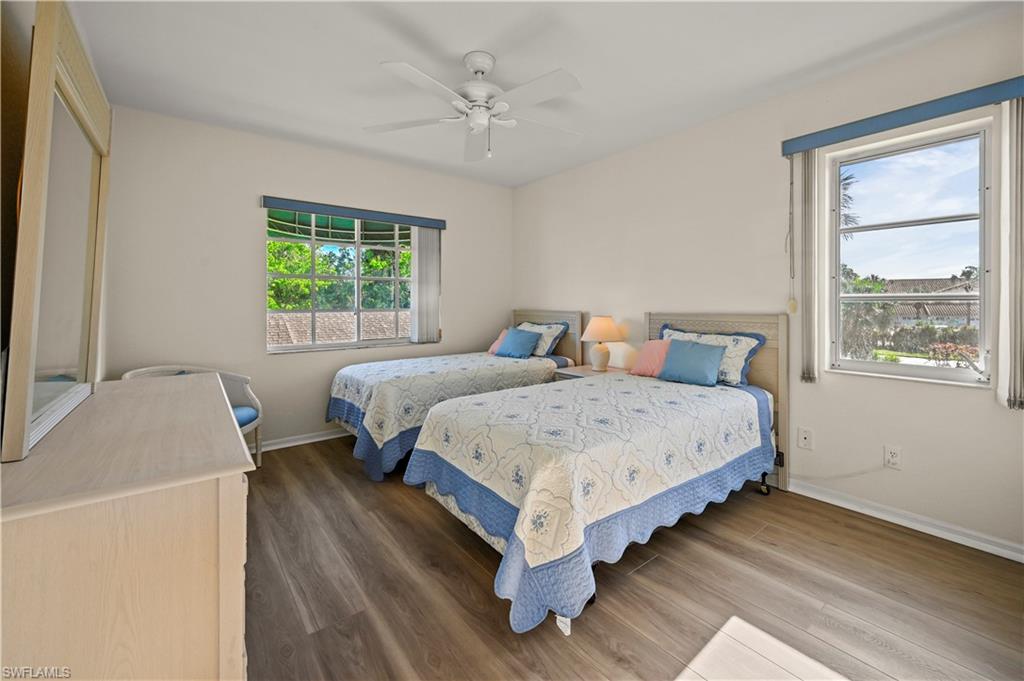249 Gabriel Circle, Unit 12 Naples, FL 34104 - Photo 21 of 40 a bedroom with a bed a window and a couch