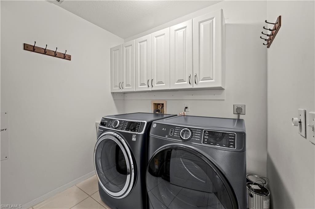 249 Gabriel Circle, Unit 12 Naples, FL 34104 - Photo 23 of 40 a utility room with dryer and washer