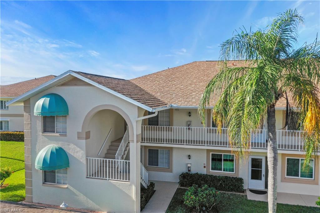 249 Gabriel Circle, Unit 12 Naples, FL 34104 - Photo 27 of 40 a front view of a house with a garden