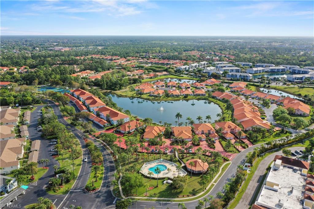 249 Gabriel Circle, Unit 12 Naples, FL 34104 - Photo 32 of 40 an aerial view of residential houses with outdoor space