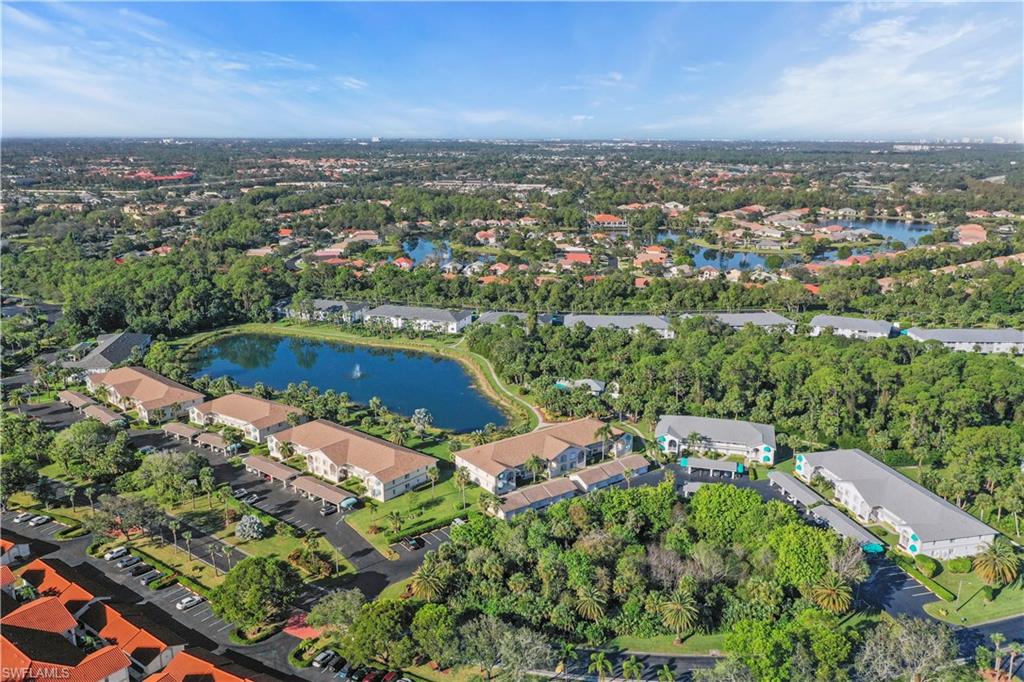 249 Gabriel Circle, Unit 12 Naples, FL 34104 - Photo 33 of 40 an aerial view of house with yard swimming pool and outdoor seating