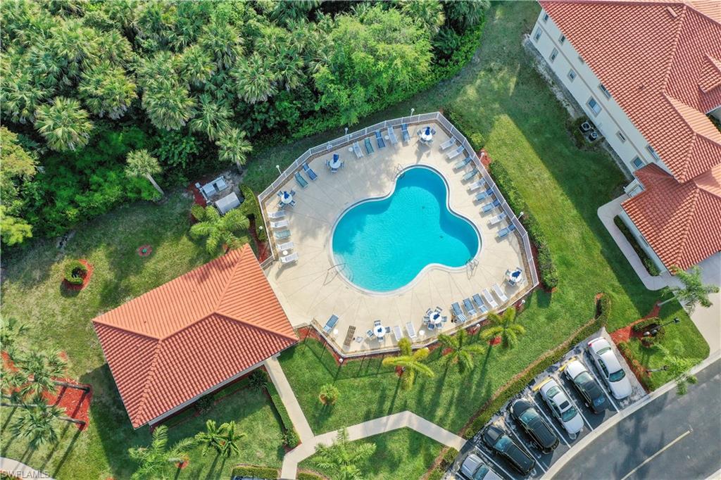 249 Gabriel Circle, Unit 12 Naples, FL 34104 - Photo 36 of 40 an aerial view of a house with a swimming pool and outdoor seating