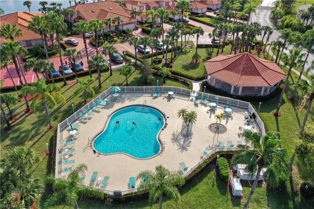 249 Gabriel Circle, Unit 12 Naples, FL 34104 - Photo 37 of 40 an aerial view of a house with a swimming pool and outdoor seating