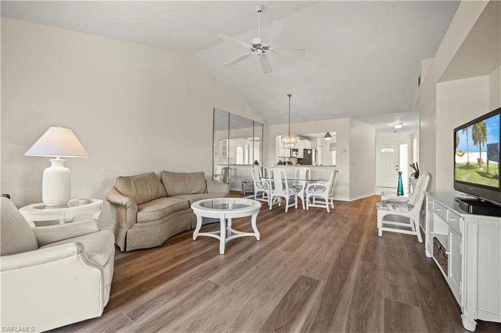 249 Gabriel Circle, Unit 12 Naples, FL 34104 - Photo 7 of 40 a living room with furniture and a flat screen tv
