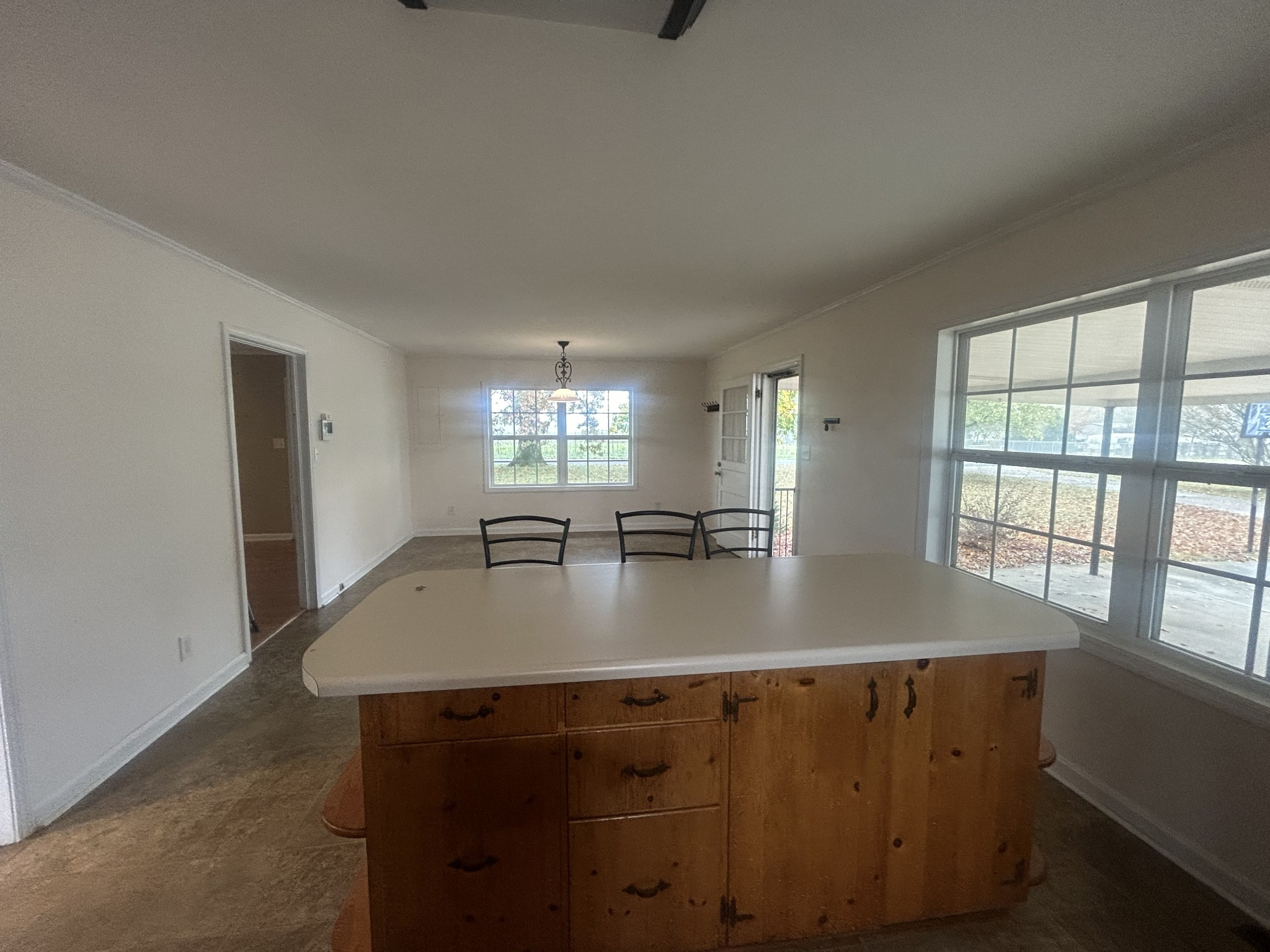 489 Lone Star Road Lawrenceburg, TN 38464 - Photo 16 of 22 a view of kitchen island a sink wooden floor dining table and chairs
