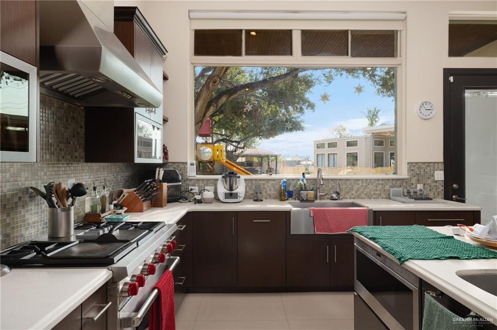 809 Rio Grande Drive Mission, TX 78572 - Photo 12 of 43 a kitchen with stainless steel appliances granite countertop a stove and a sink