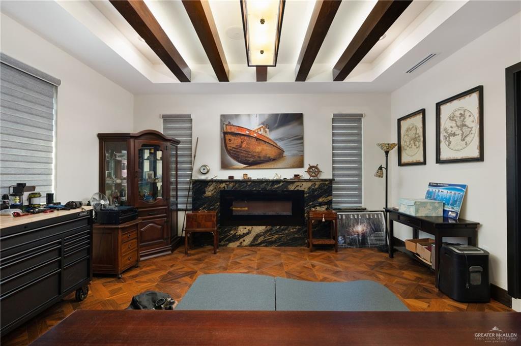 809 Rio Grande Drive Mission, TX 78572 - Photo 13 of 43 a living room with furniture a fireplace and paintings on the wall