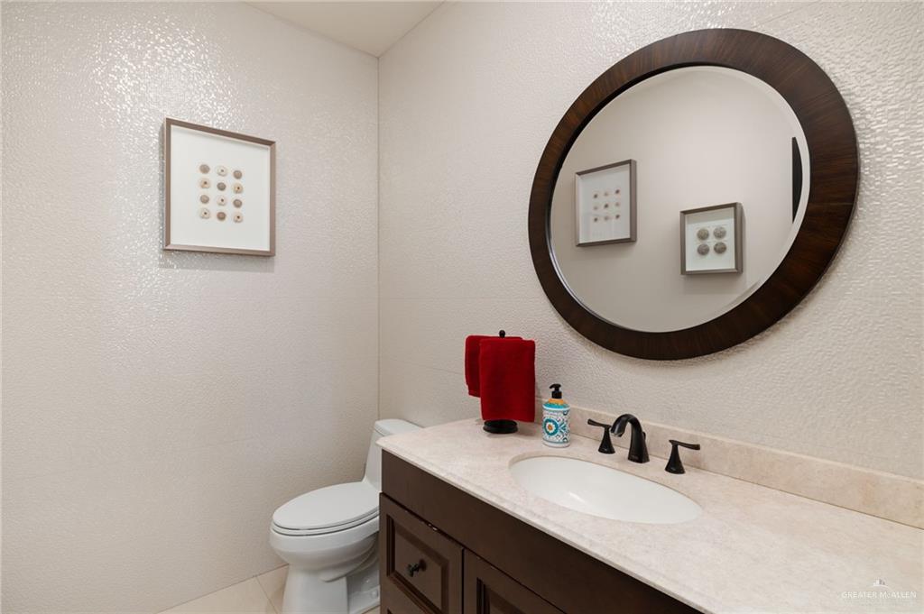 809 Rio Grande Drive Mission, TX 78572 - Photo 16 of 43 a bathroom with a toilet a sink and a mirror
