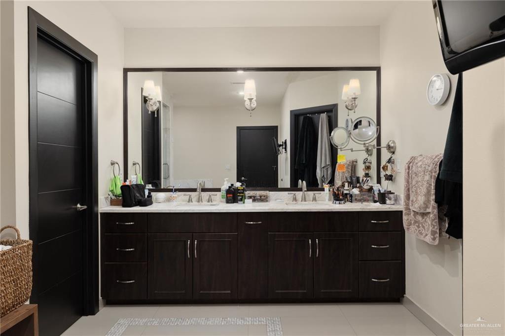 809 Rio Grande Drive Mission, TX 78572 - Photo 18 of 43 a bathroom with a double vanity sink and mirror