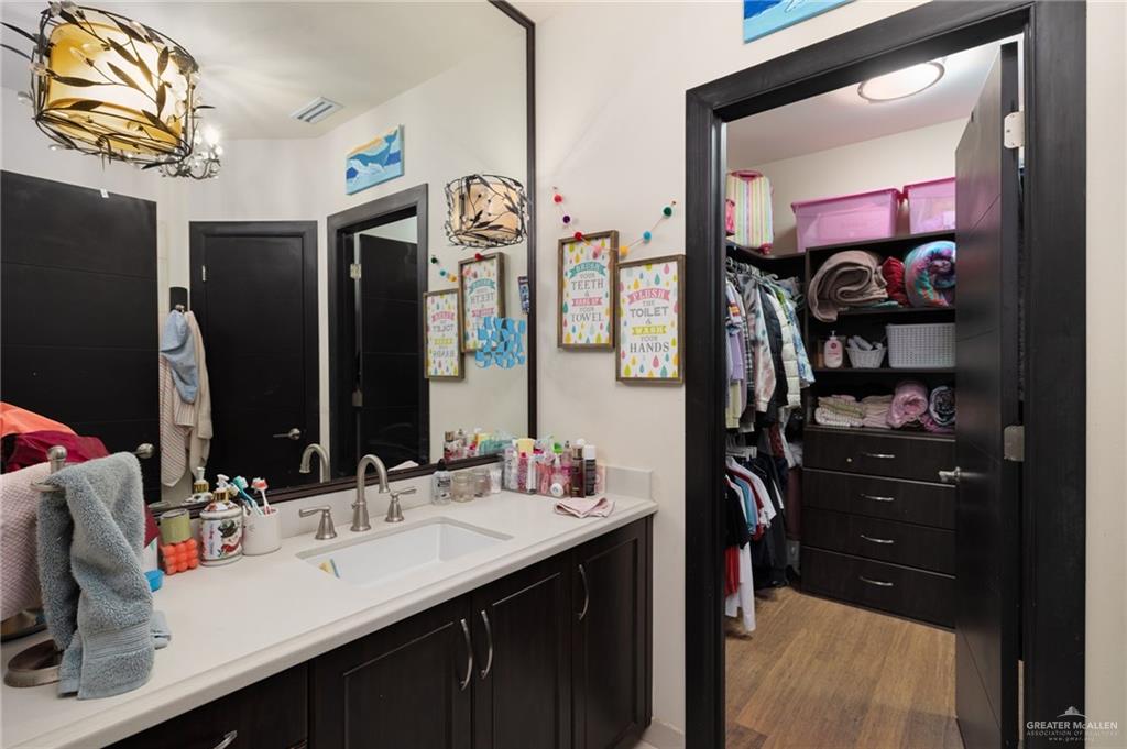 809 Rio Grande Drive Mission, TX 78572 - Photo 22 of 43 a en suite bathroom with a sink double vanity and a mirror